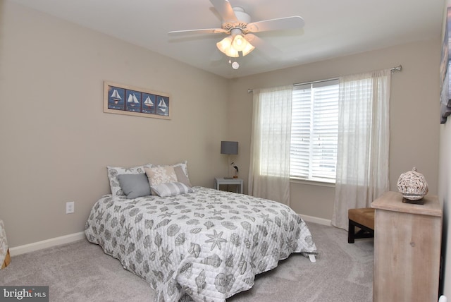 bedroom featuring baseboards, ceiling fan, and carpet