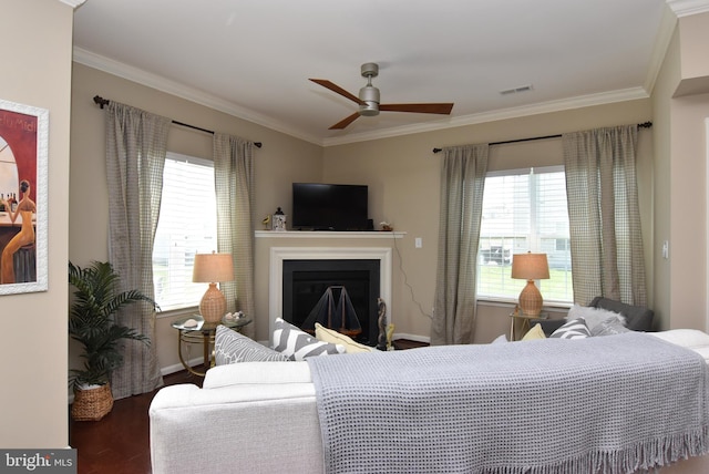 bedroom featuring visible vents, a fireplace, wood finished floors, baseboards, and ornamental molding