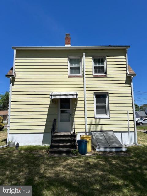 2081 S Olden Ave, Hamilton, NJ 08610 - back of property with a yard, a chimney, and entry steps