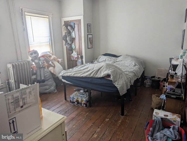 bedroom with hardwood / wood-style flooring