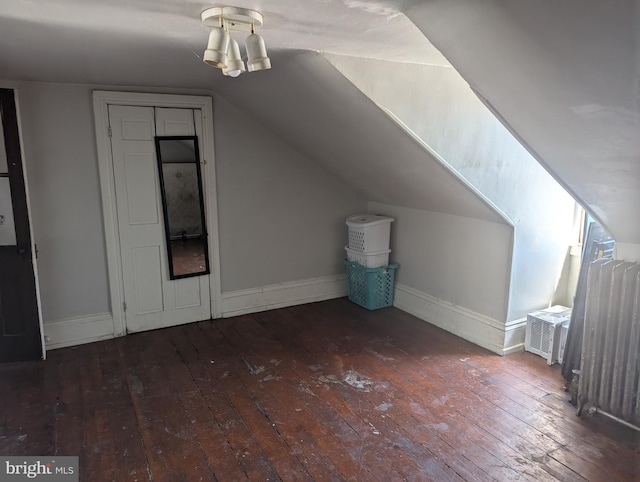 bonus room with baseboards, vaulted ceiling, and hardwood / wood-style flooring
