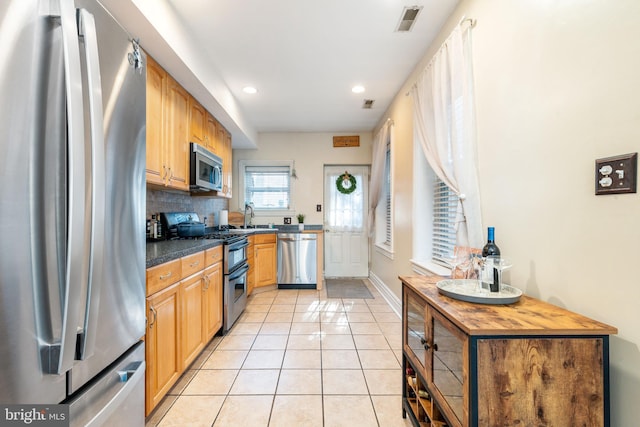 kitchen with light tile patterned flooring, appliances with stainless steel finishes, recessed lighting, baseboards, and visible vents
