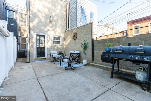 view of patio featuring fence and cooling unit