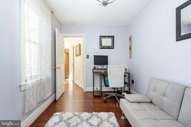 home office with baseboards and wood finished floors