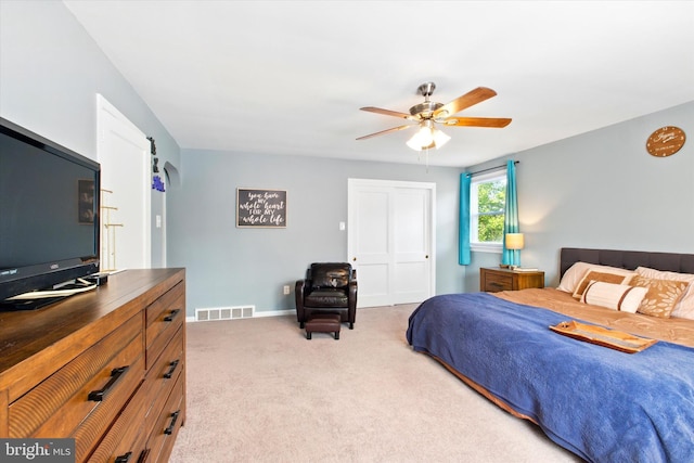 bedroom with baseboards, visible vents, a ceiling fan, and light colored carpet