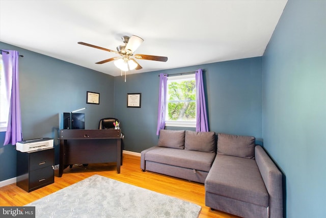 office with baseboards, a ceiling fan, and light wood finished floors