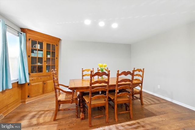 dining space featuring baseboards and light wood-style floors