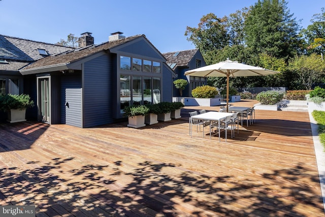 wooden terrace with outdoor dining space