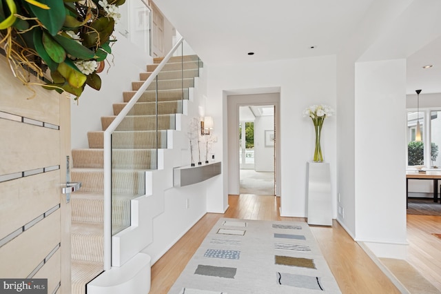 entrance foyer with recessed lighting, light wood finished floors, and stairs