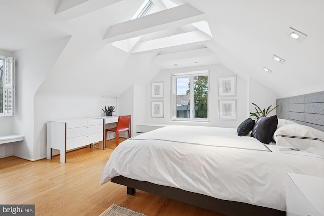 bedroom featuring vaulted ceiling and light wood-type flooring
