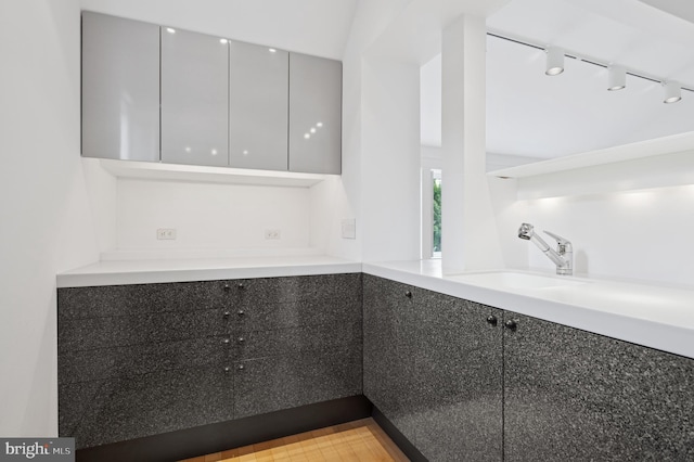 interior space featuring track lighting and a sink