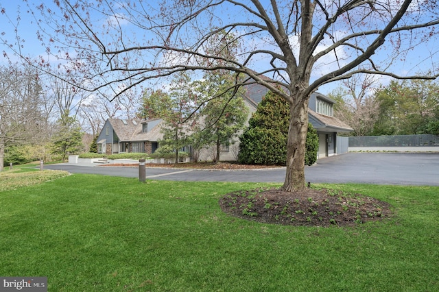 view of yard featuring aphalt driveway