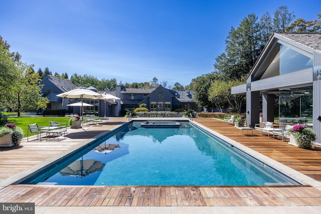 pool with a lawn and a wooden deck