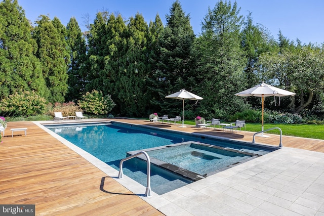 view of swimming pool featuring a yard, a deck, a pool with connected hot tub, and a patio