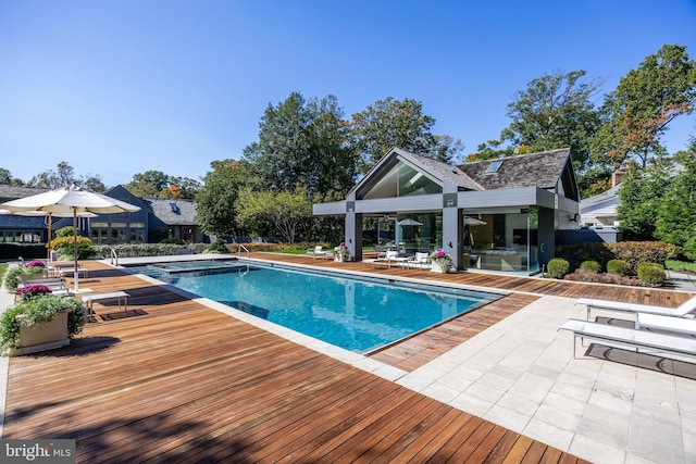 outdoor pool with an outbuilding, an exterior structure, and a patio area