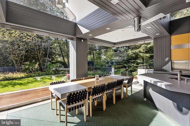 view of patio with fence, a sink, outdoor dry bar, and a deck