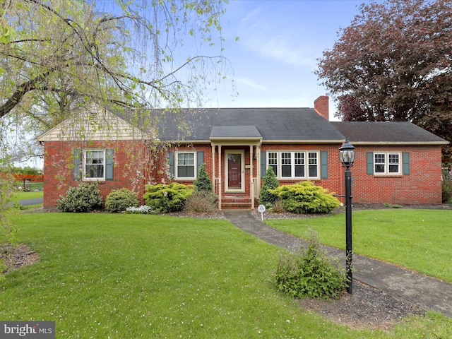 128 Orchard Cir, Greencastle, PA 17225 - ranch-style house featuring a shingled roof, a chimney, a front yard, and brick siding