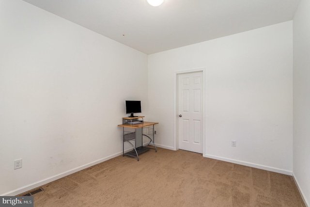 spare room featuring baseboards, carpet, and visible vents