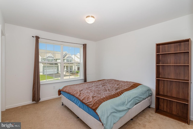 carpeted bedroom with baseboards