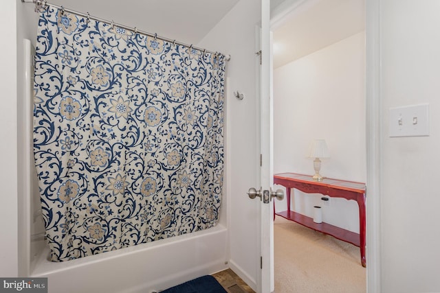 full bathroom featuring baseboards and shower / bath combo with shower curtain
