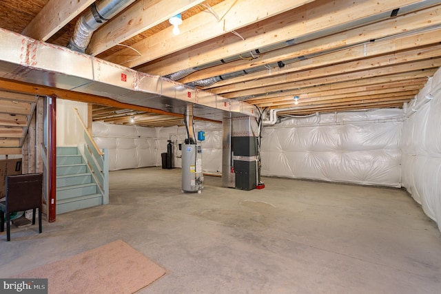 unfinished basement with stairs, heating unit, and water heater