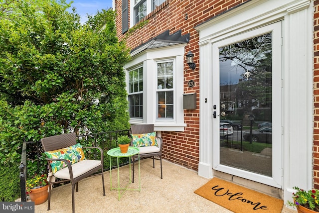 doorway to property featuring brick siding