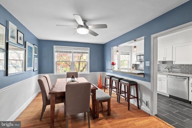 dining area featuring ceiling fan and wood finished floors