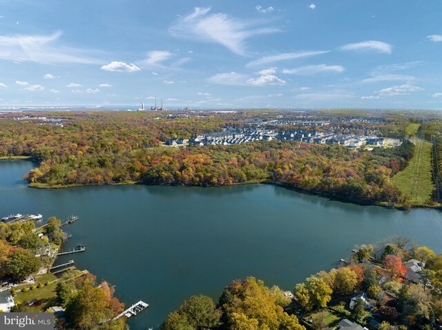 bird's eye view featuring a wooded view and a water view