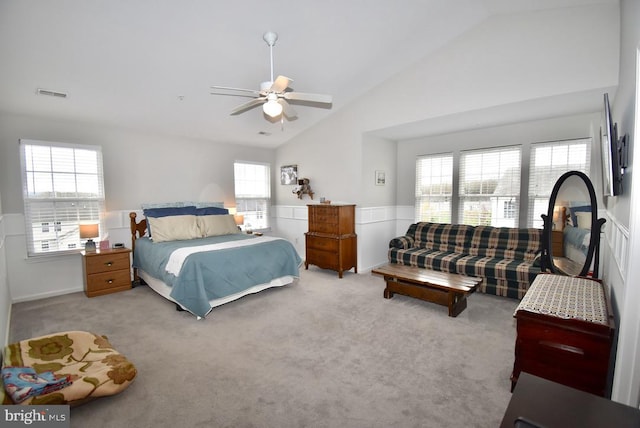 carpeted bedroom featuring visible vents, a ceiling fan, wainscoting, and high vaulted ceiling