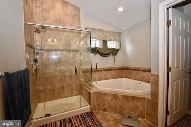 full bath featuring lofted ceiling, a shower stall, a bath, and tile patterned flooring