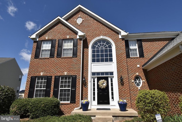 view of front of house featuring brick siding
