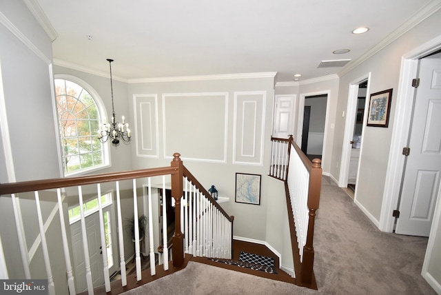 stairway with ornamental molding, an inviting chandelier, baseboards, and visible vents
