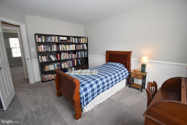carpeted bedroom featuring baseboards