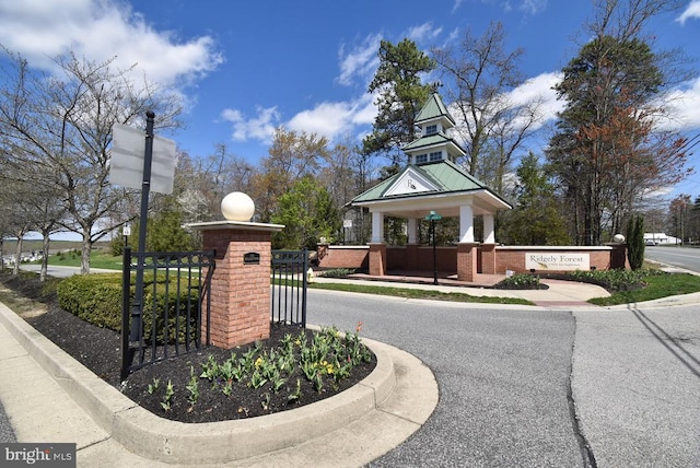 exterior space with curbs, sidewalks, and street lights