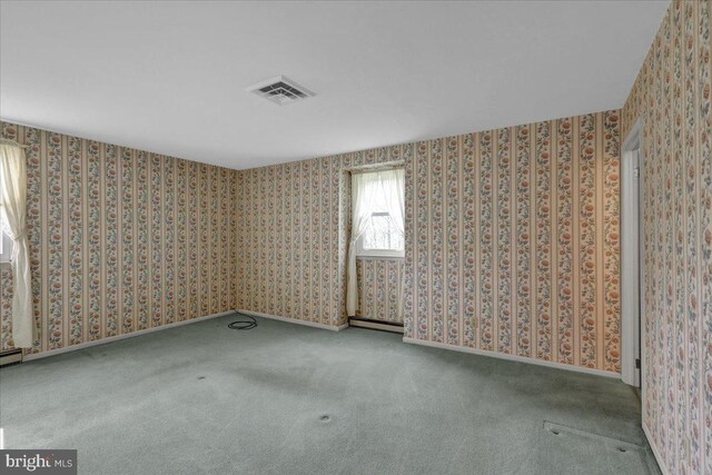 carpeted empty room with visible vents and wallpapered walls