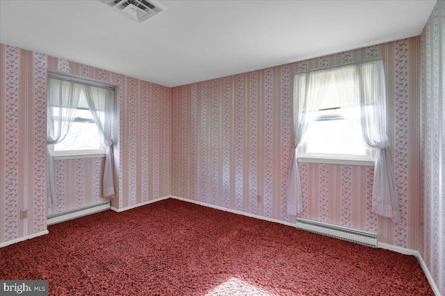 carpeted empty room with visible vents, a healthy amount of sunlight, and a baseboard radiator