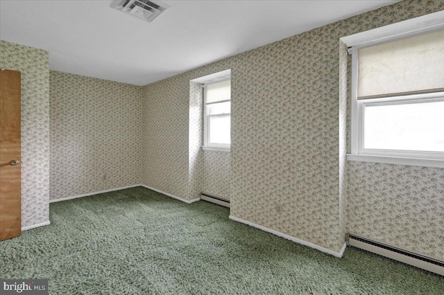 interior space with visible vents, baseboard heating, and carpet floors