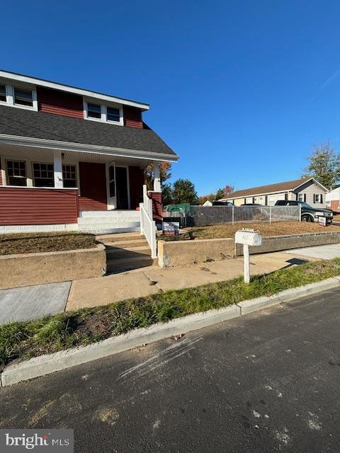 bungalow-style house featuring fence and covered porch