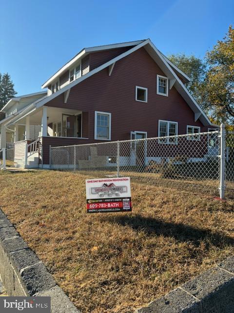 view of home's exterior featuring a yard and fence