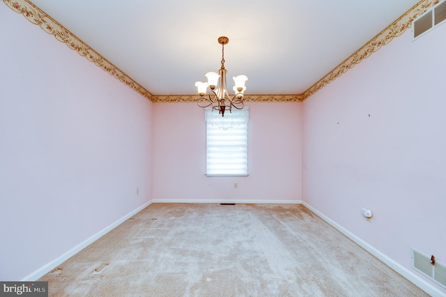 unfurnished room with carpet floors, a notable chandelier, visible vents, and baseboards