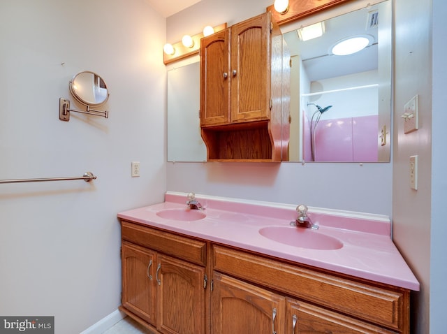 bathroom with a sink and double vanity