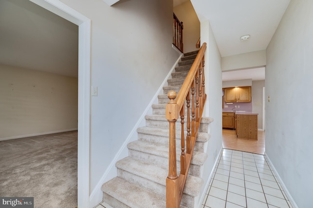 staircase with tile patterned floors and baseboards