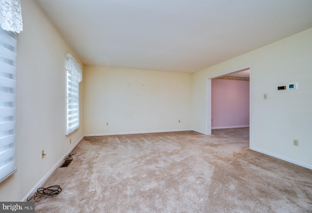 carpeted empty room with baseboards