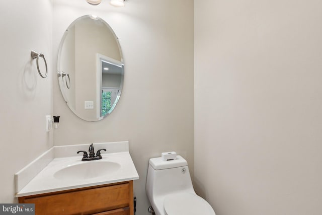half bathroom with vanity and toilet