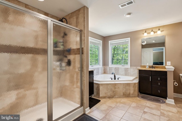 bathroom with visible vents, a stall shower, a bath, and vanity