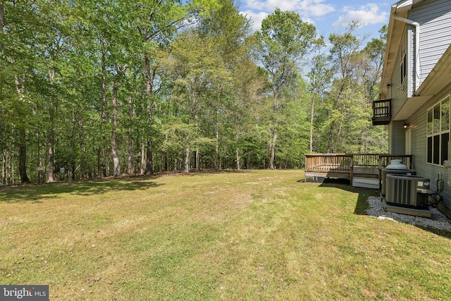 view of yard featuring a wooden deck, a balcony, and cooling unit