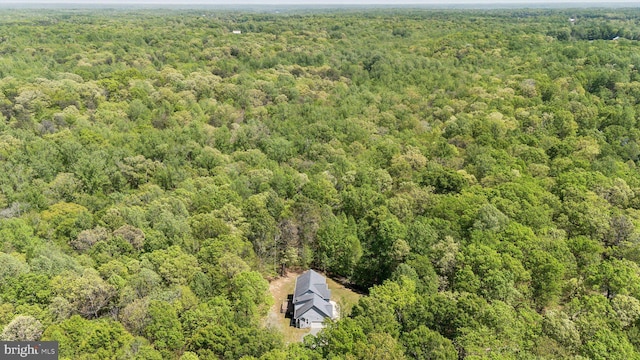 birds eye view of property featuring a wooded view