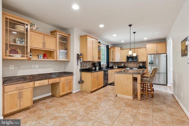 kitchen featuring built in study area, light brown cabinetry, backsplash, and stainless steel appliances