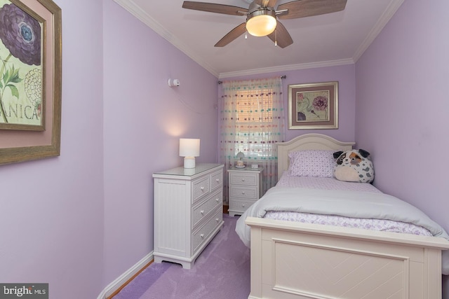carpeted bedroom with baseboards, ornamental molding, and a ceiling fan
