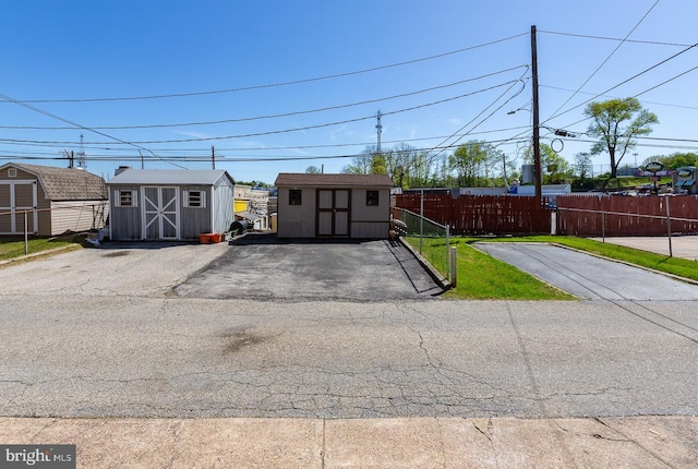 exterior space with a storage shed and fence